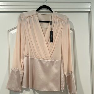 100% Silk Elie Tahari blouse with peplum and side zip. NWT!